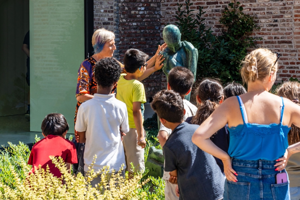 Groep dat sculptuur aanraakt
